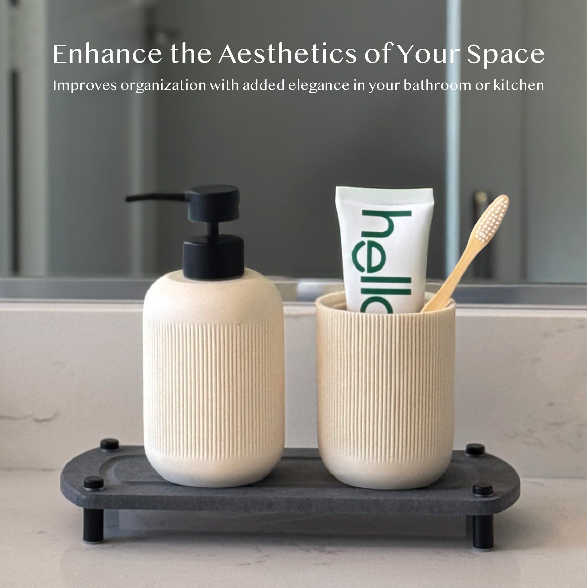 A dark gray sink caddy sits on a bathroom countertop with a toothbrush and toothpaste casually laid on top.