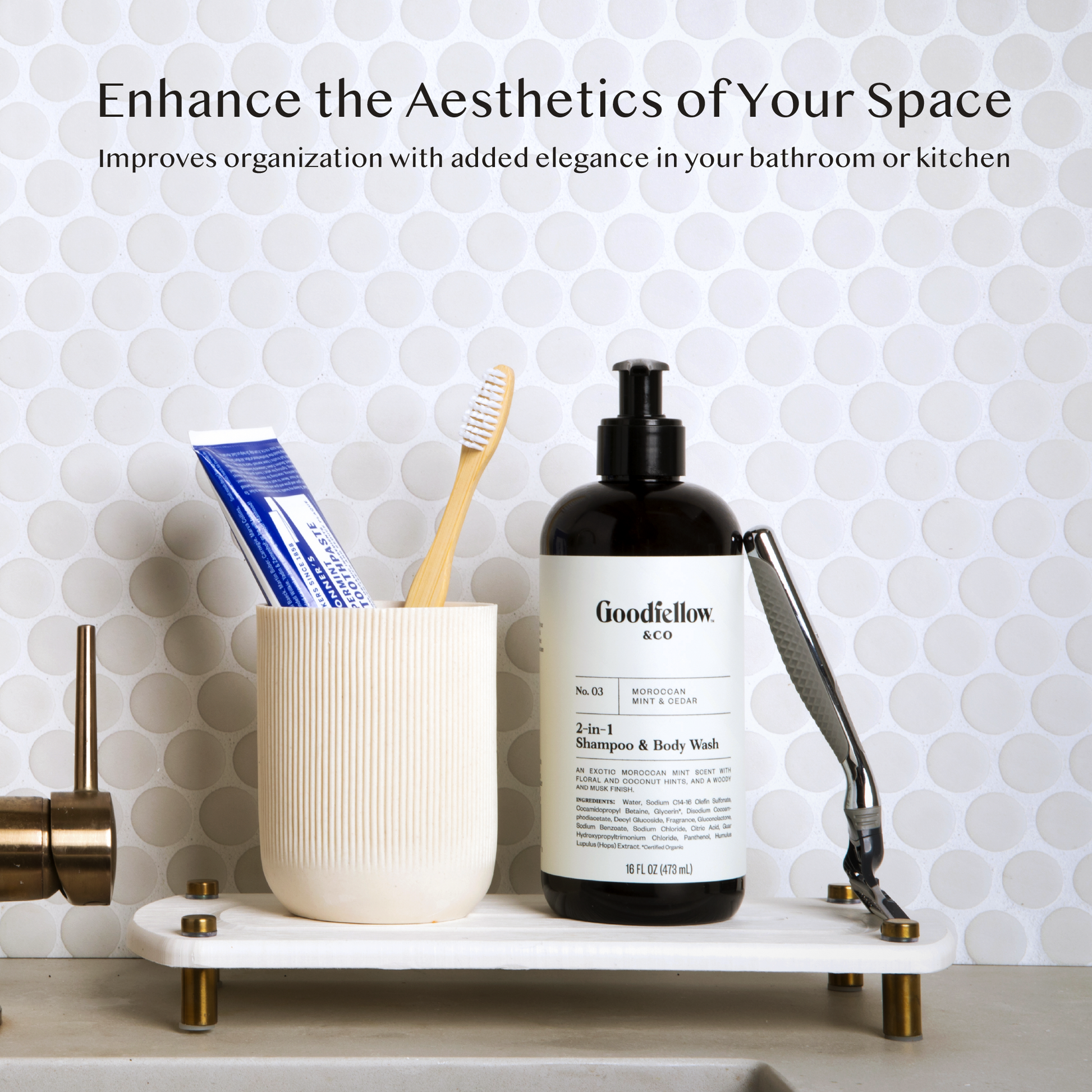 A white sink caddy sits on a countertop next to a gold faucet handle. On the caddy, a toothbrush and toothpaste in a holder are arranged, while nearby are a bottle of men's shampoo, body wash, and a razor positioned next to the shampoo bottle.