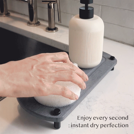A GIF shows a woman's hand removing a sponge from a glacier gray sink caddy, with water evaporating instantly to showcase its fast drying performance.