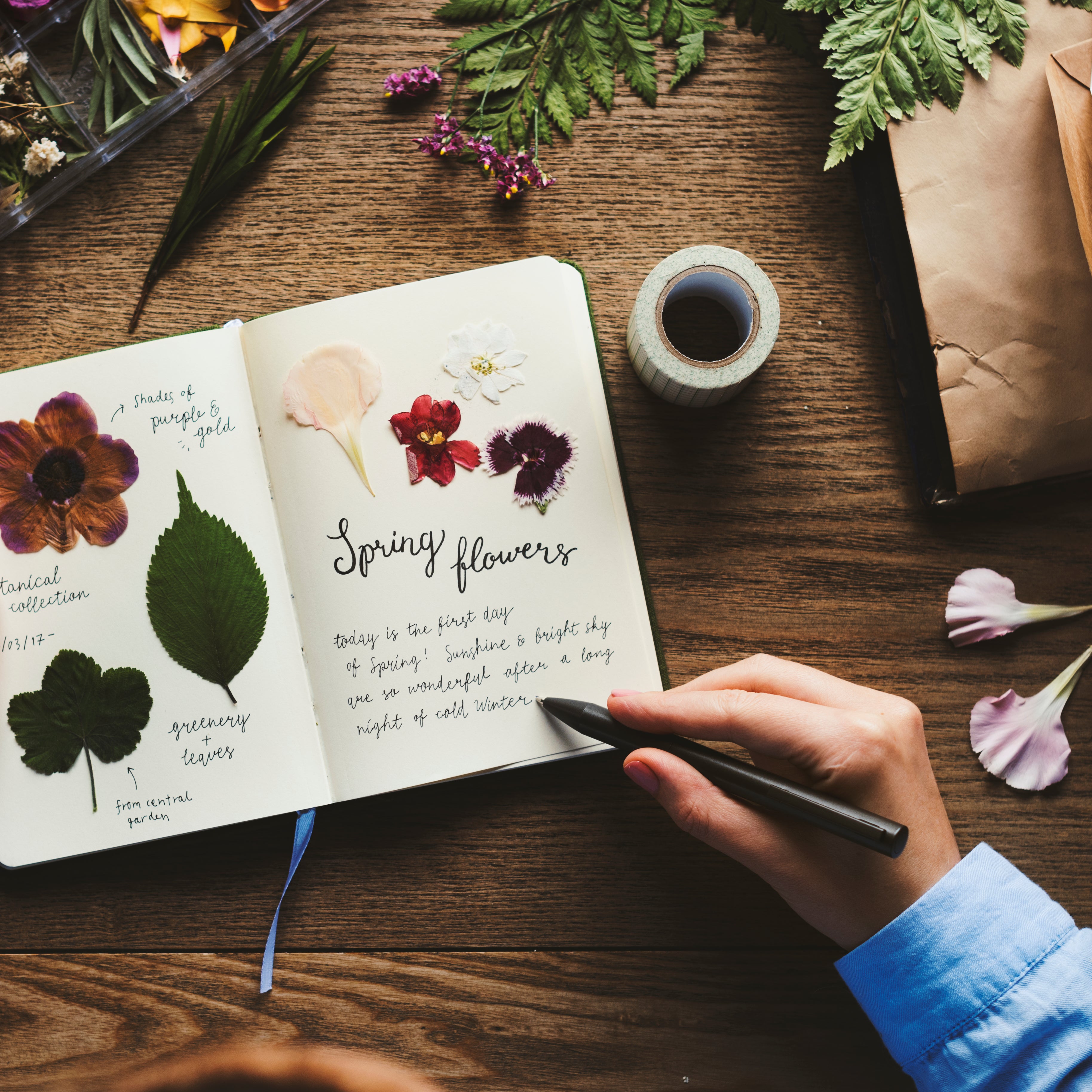 scrapbooking spring flowers and writing comments with pen